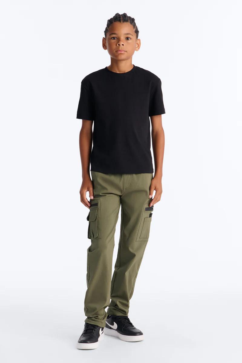 Boy's black t-shirt and olive cargo pants with sneakers. Kids fashion.
