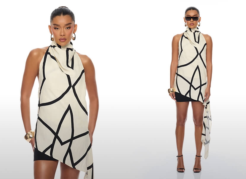 Modelo con túnica crema cuello halter y líneas geométricas negras, shorts y accesorios dorados, exhibiendo moda moderna.