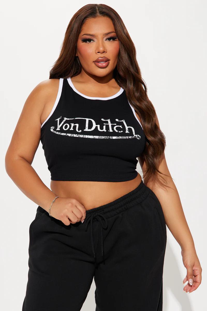 Plus size woman wearing a black Von Dutch crop top tank and black sweatpants.