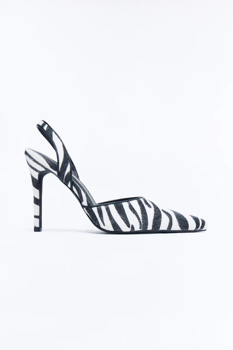 Pointed toe zebra print slingback heels with high stiletto heel.
