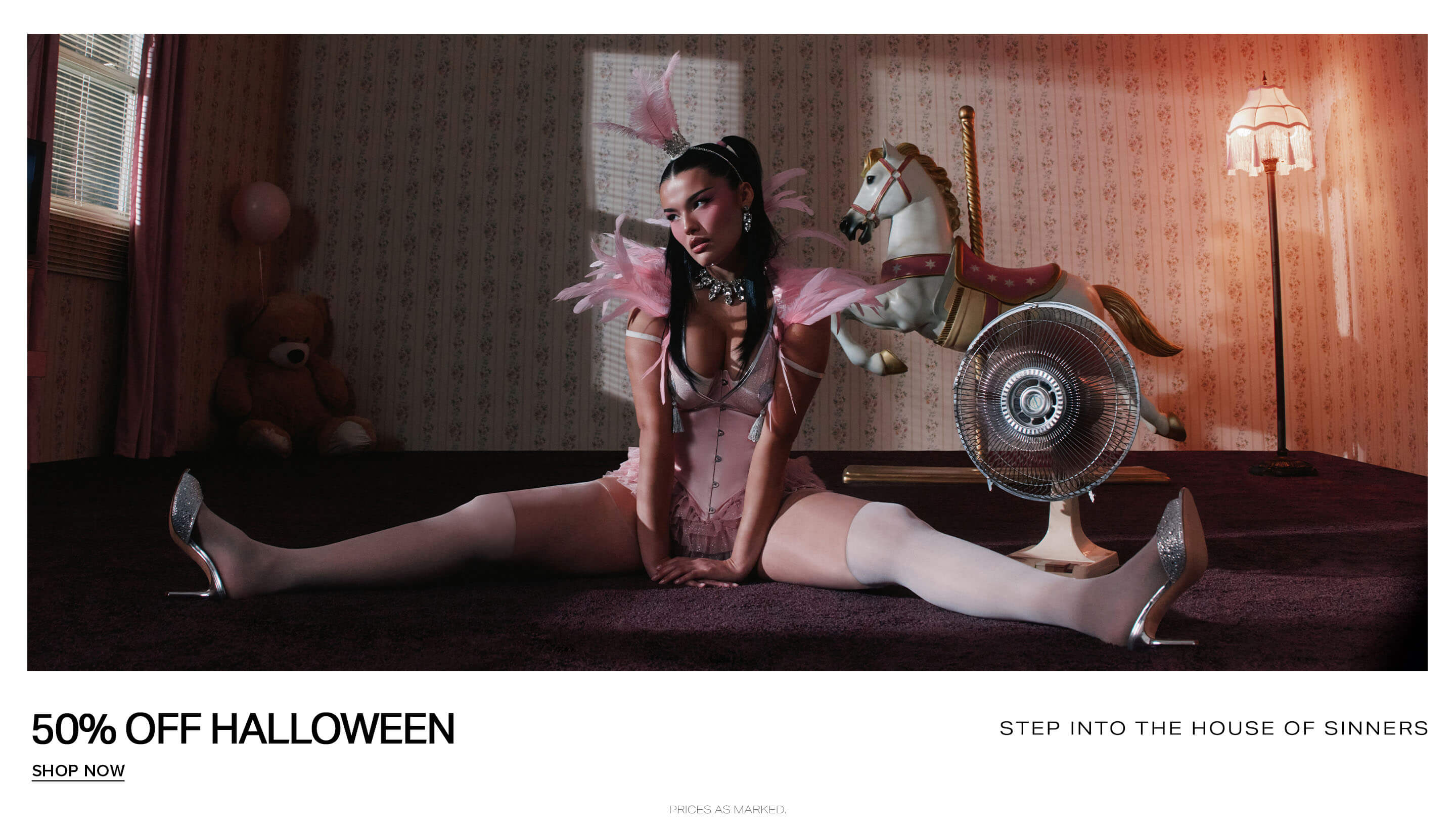 Model wearing a pink feathered corset costume posing for a 50% off Halloween sale ad promoting the House of Sinners collection.