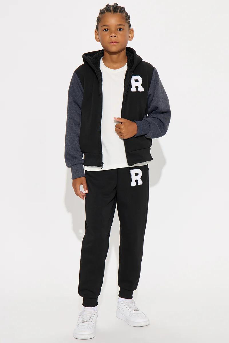 Boys black and grey varsity hoodie and jogger sweatpants set with white letter R.