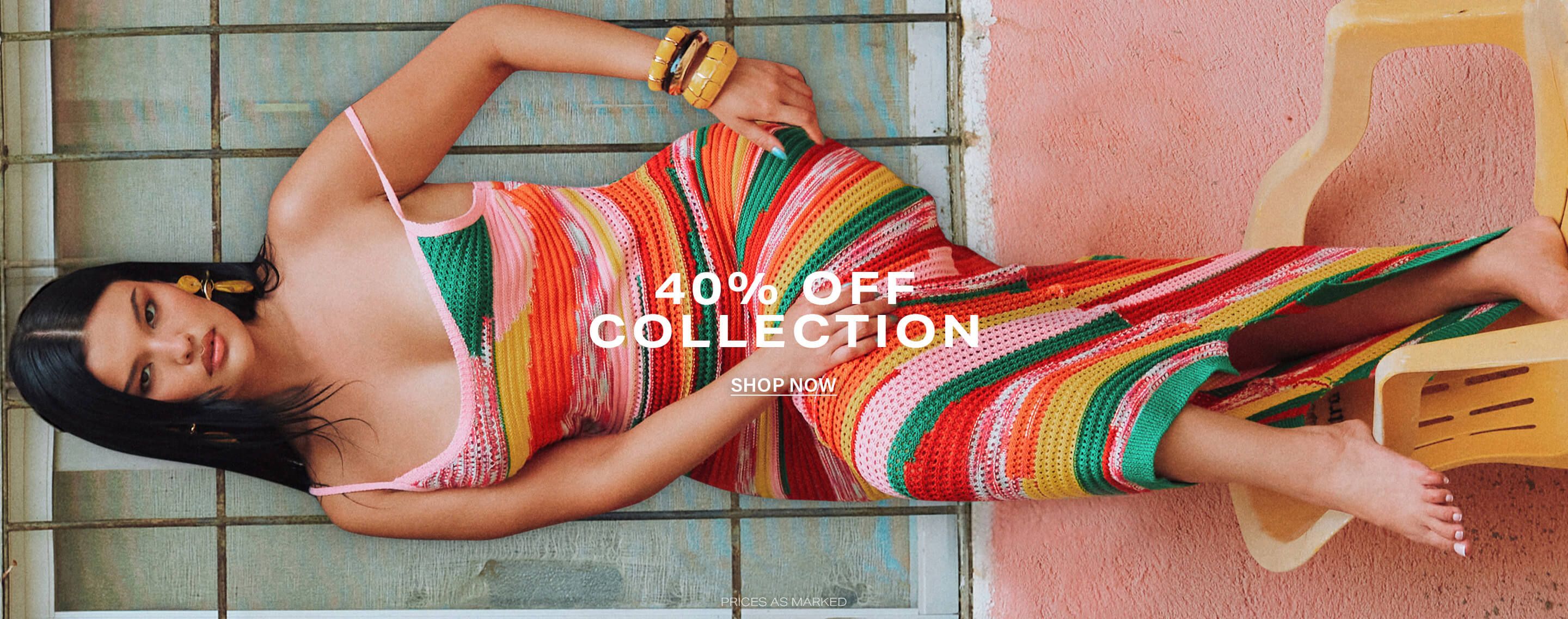 Stylish woman in vibrant multi-color striped crochet knit dress against a pink wall. Promote 40% off fashion collection sale. Shop now!