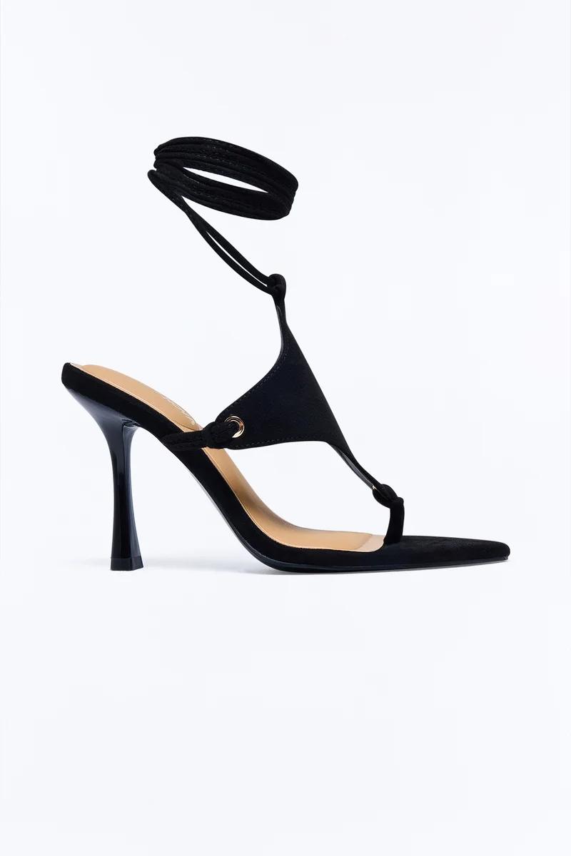 Elegant black lace-up high heel sandals with an ankle wrap and stiletto heel.