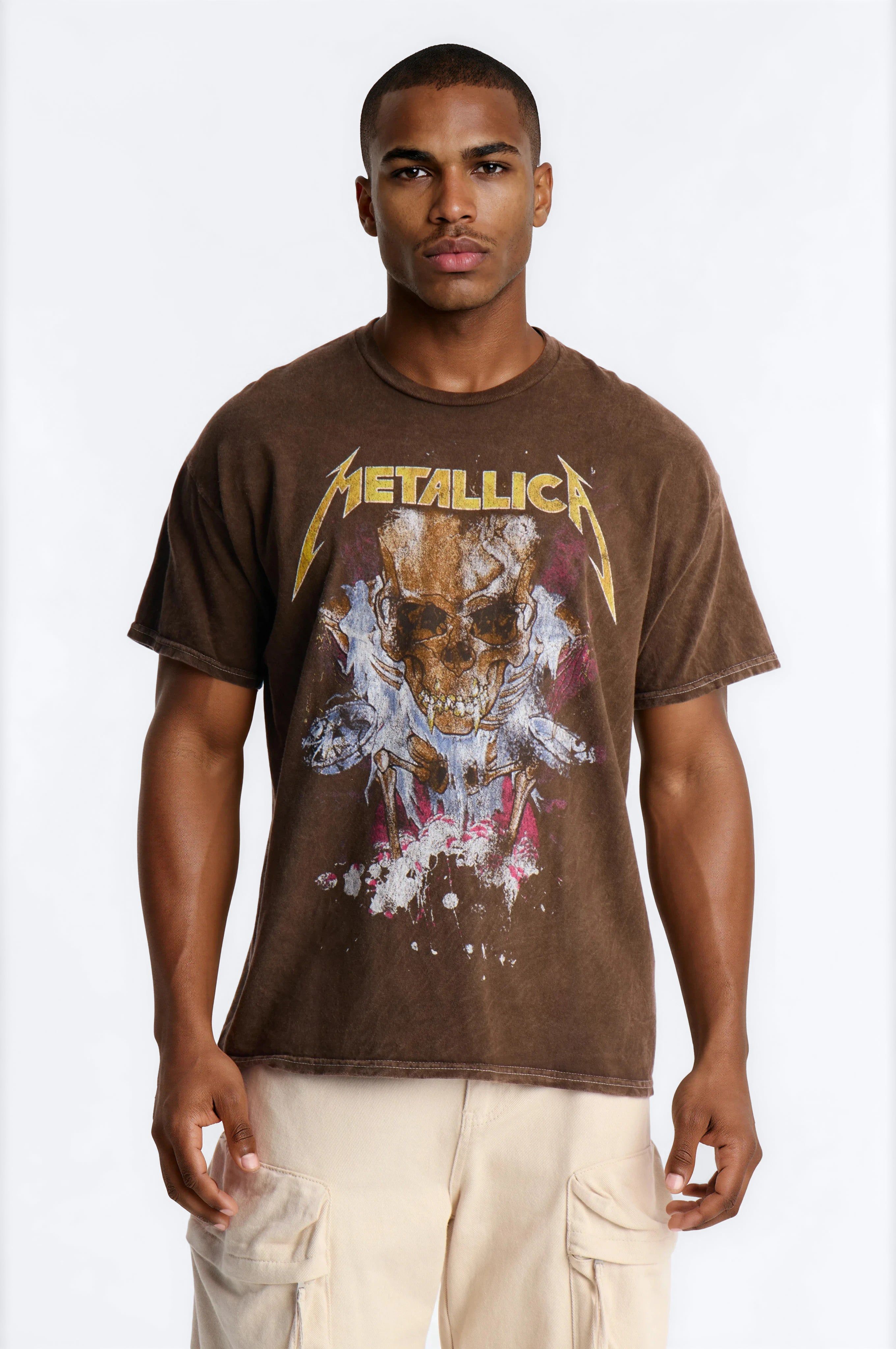 Man models a black sleeveless "Rebellion" graphic tee with striking red stars and skull designs, showcasing modern streetwear fashion.