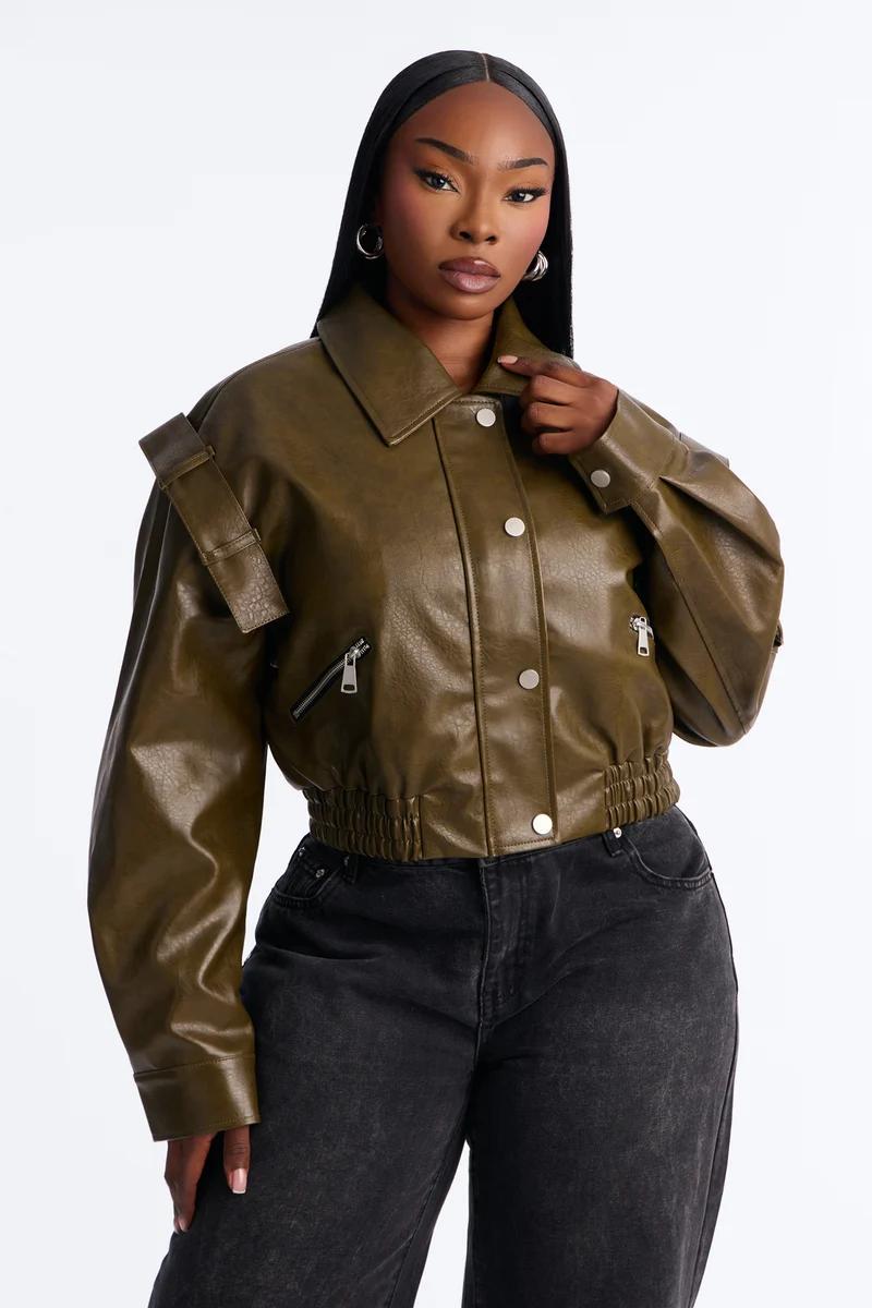 Cropped olive green faux leather jacket for women styled with black jeans.