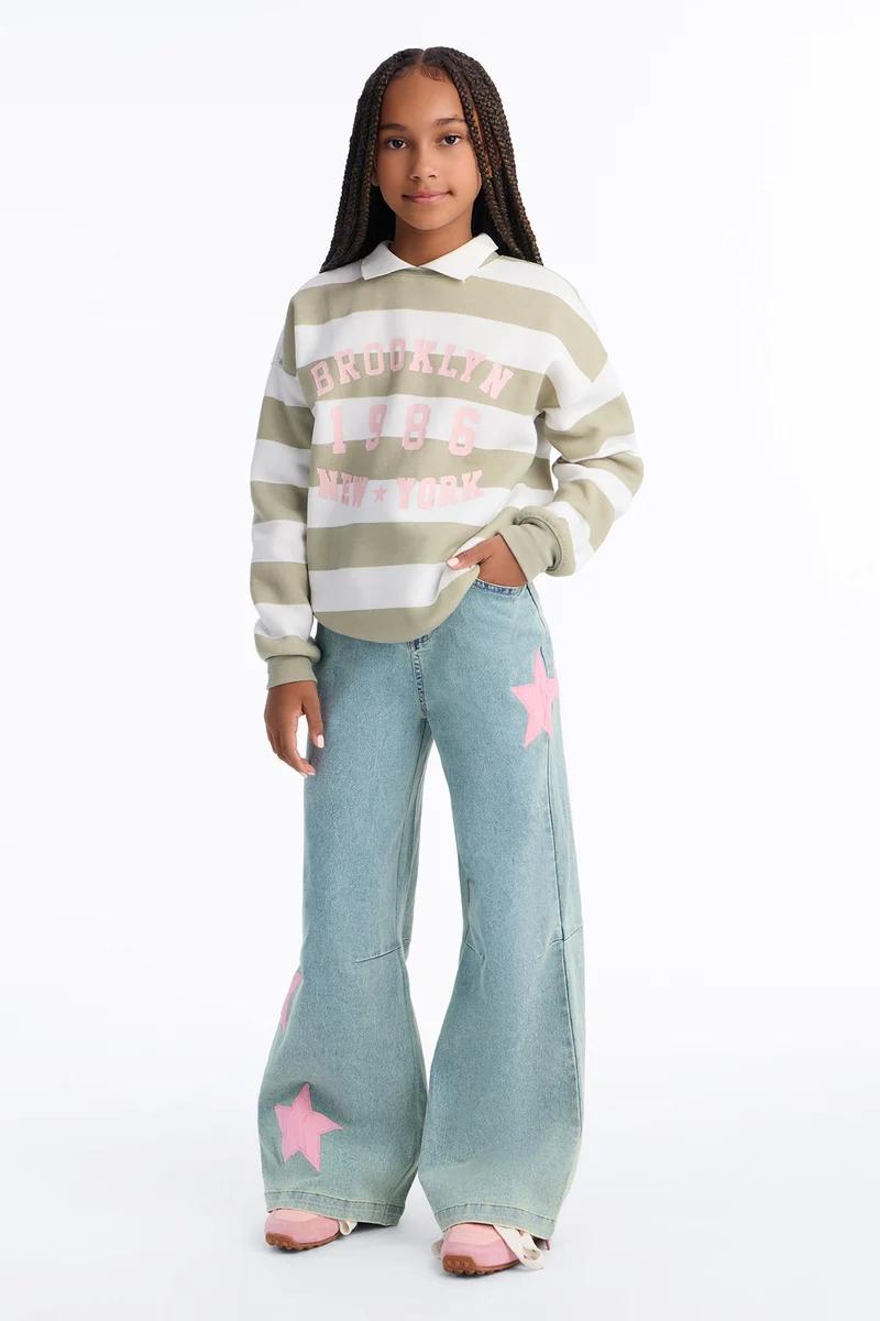 Girls' striped Brooklyn sweatshirt and wide-leg jeans with pink star patches.