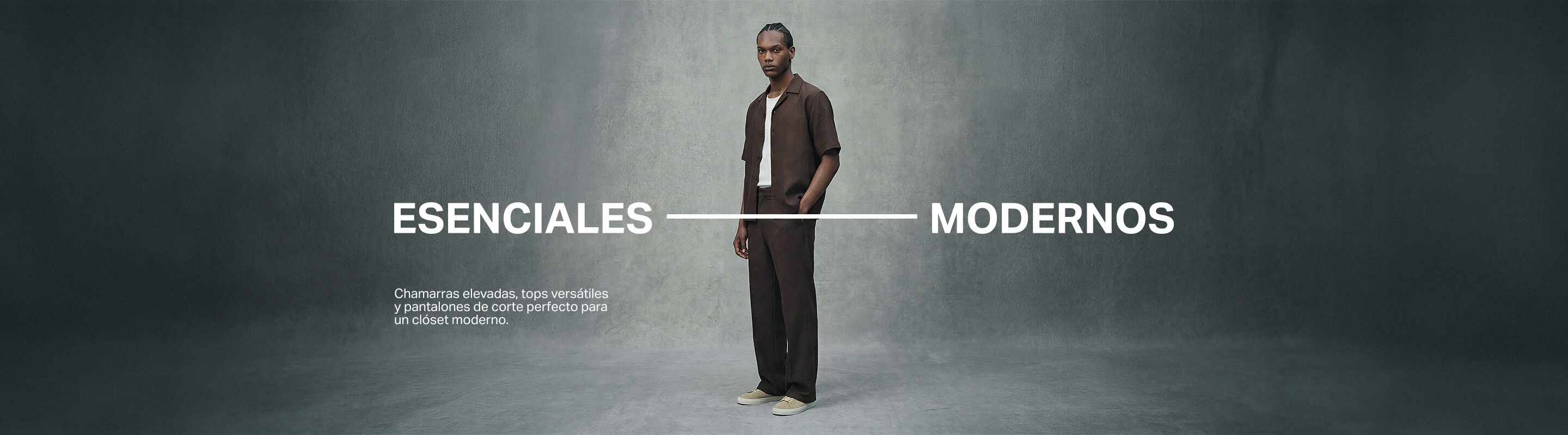Hombre con camisa marrón, camiseta blanca, pantalón sastre y zapatillas, para básicos modernos y versátiles de vestuario.