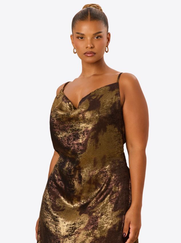 Plus-size woman wearing a metallic gold and bronze cowl neck slip dress.