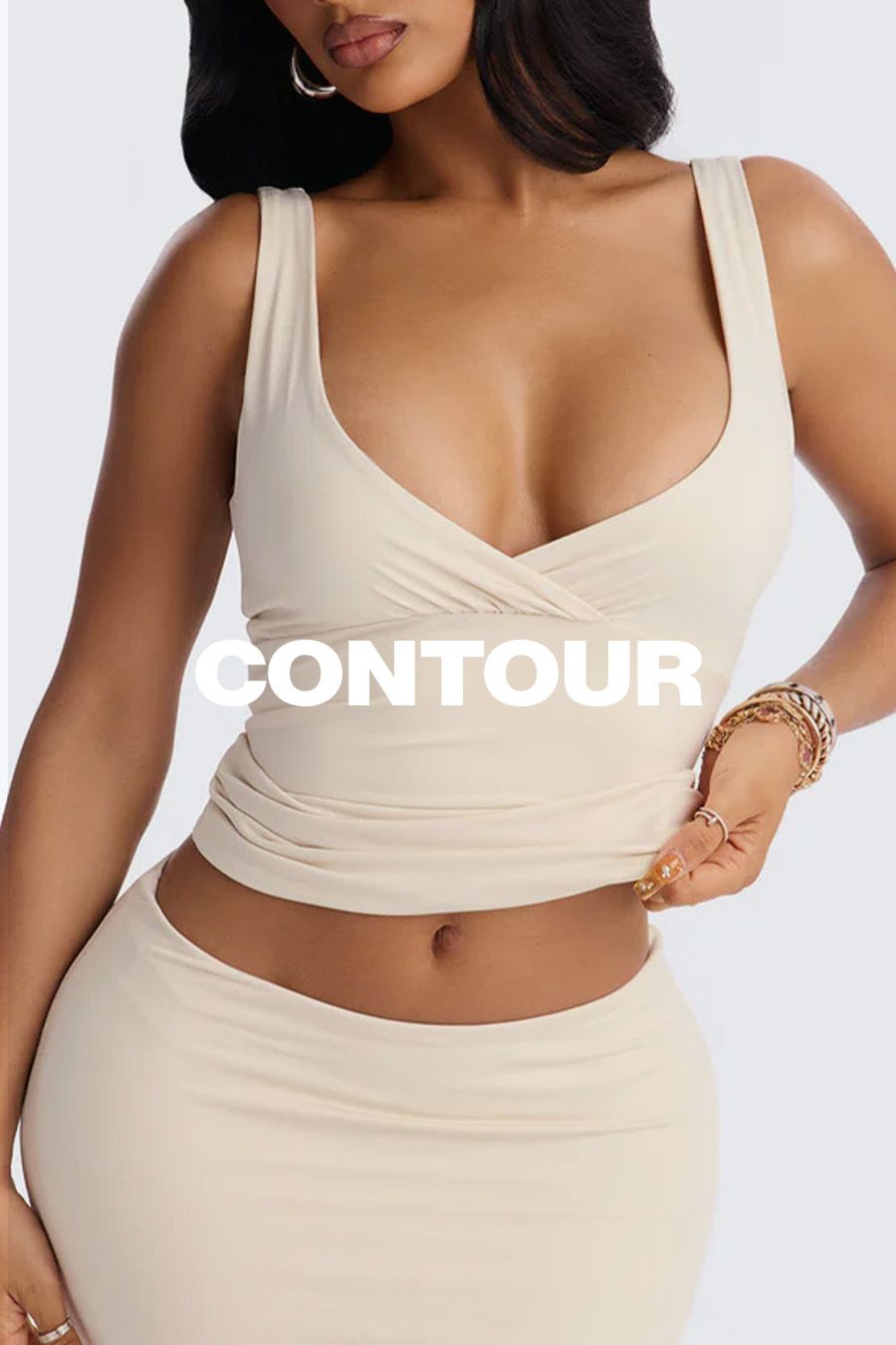 Model wearing a beige matching crop top and skirt set from the Contour sculpting collection, highlighting neutral-toned loungewear.