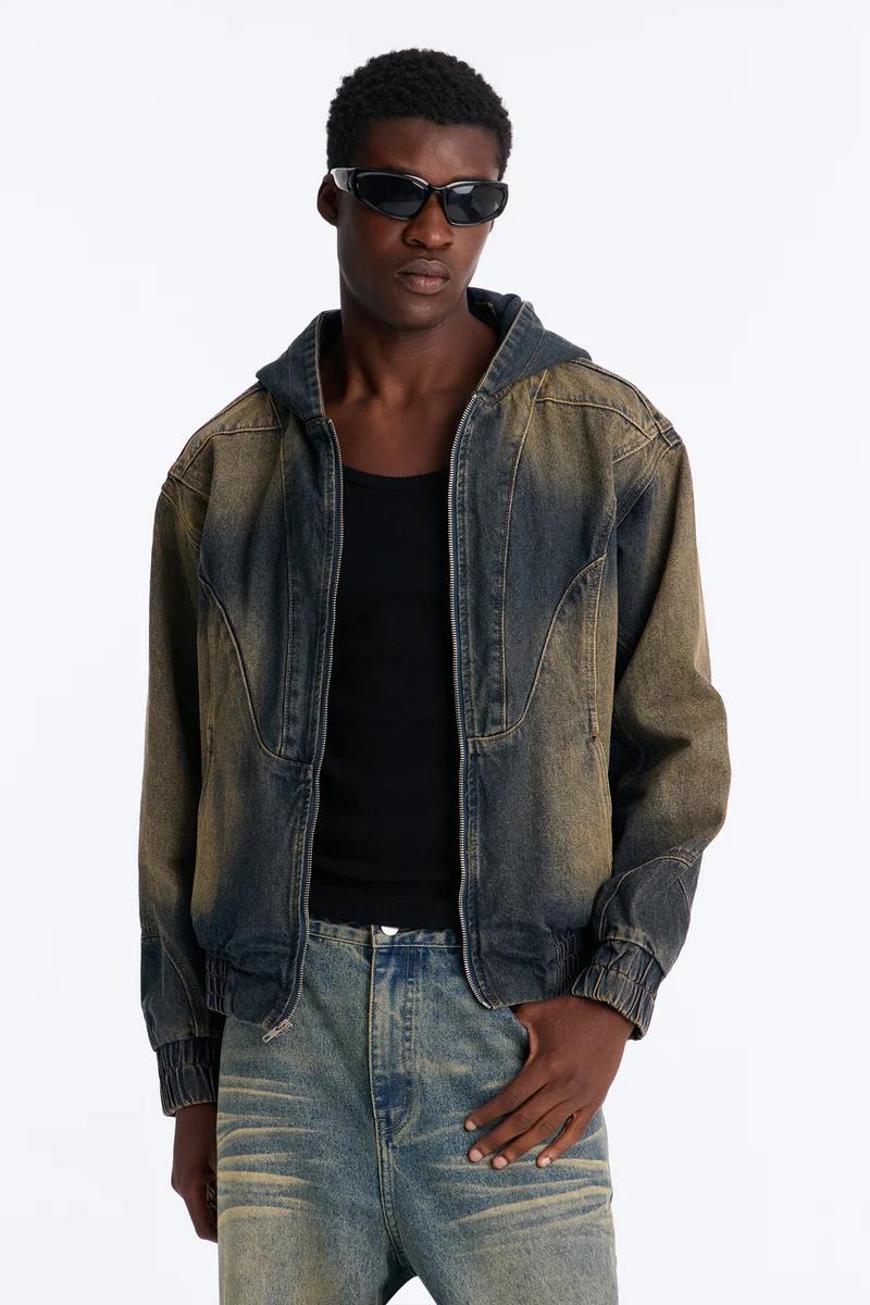 Man in acid wash denim hooded jacket, black tank top, and distressed jeans. Modern sunglasses complete this new streetwear look.