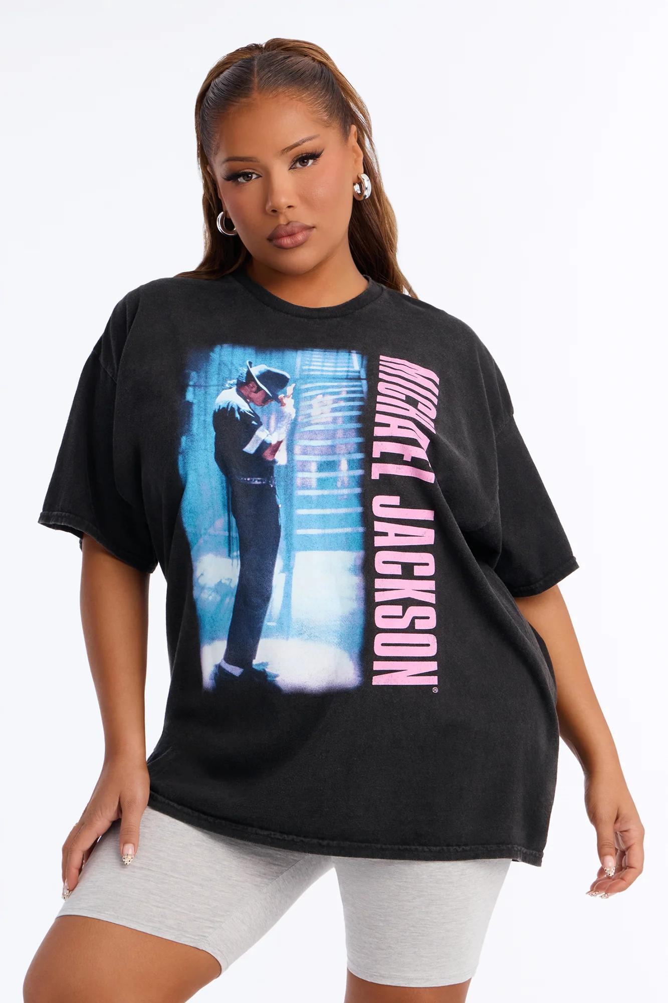 Woman wearing an oversized black Michael Jackson graphic t-shirt with pink text.
