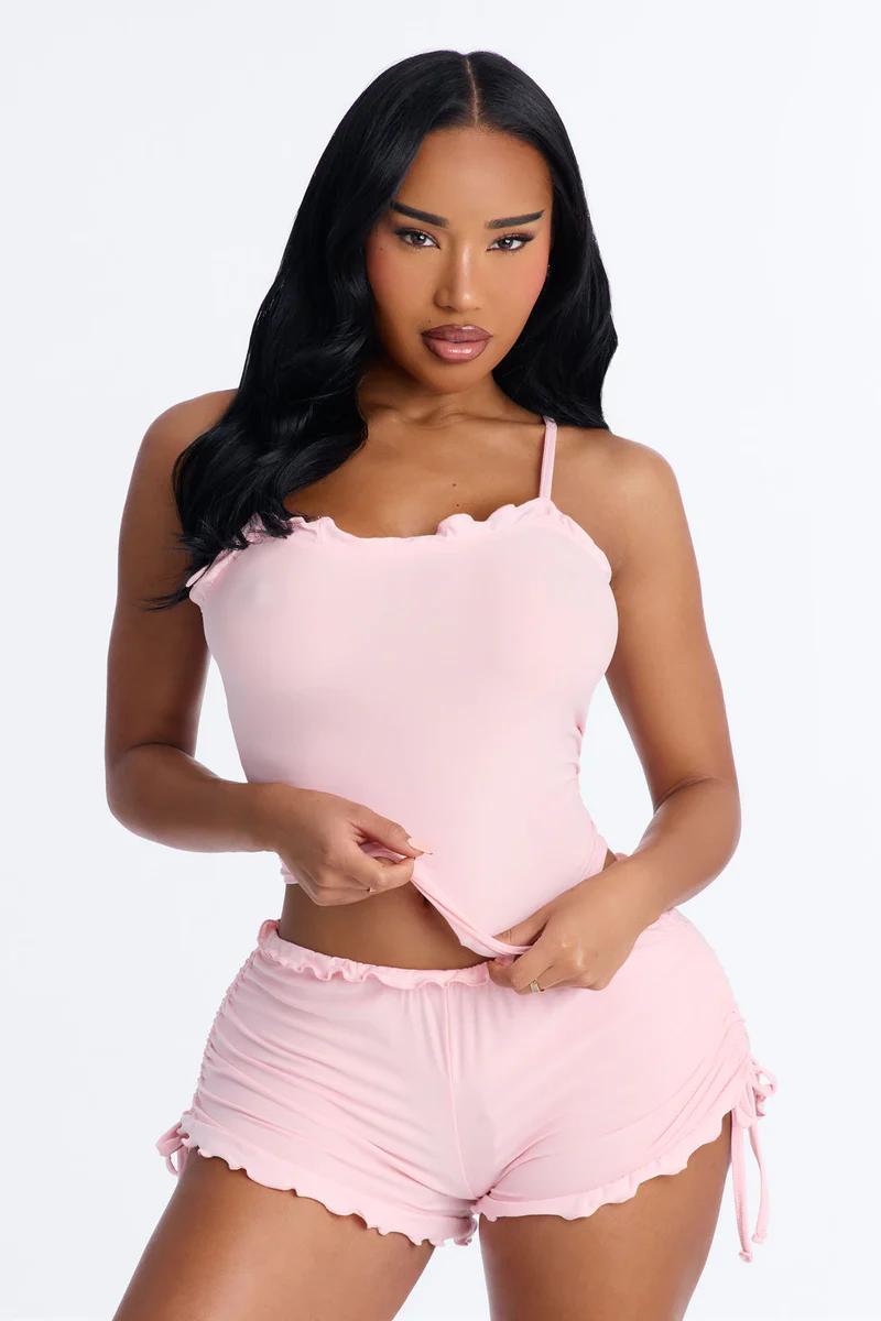 Cute pink ruffled pajama set: camisole top & ruched shorts. Stylish & comfy women's loungewear.