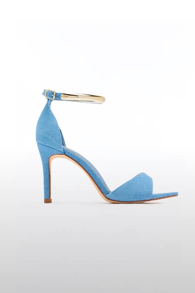 Light blue denim high heel sandal featuring a gold-tone ankle strap and stiletto heel. A stylish new arrival for women's fashion.