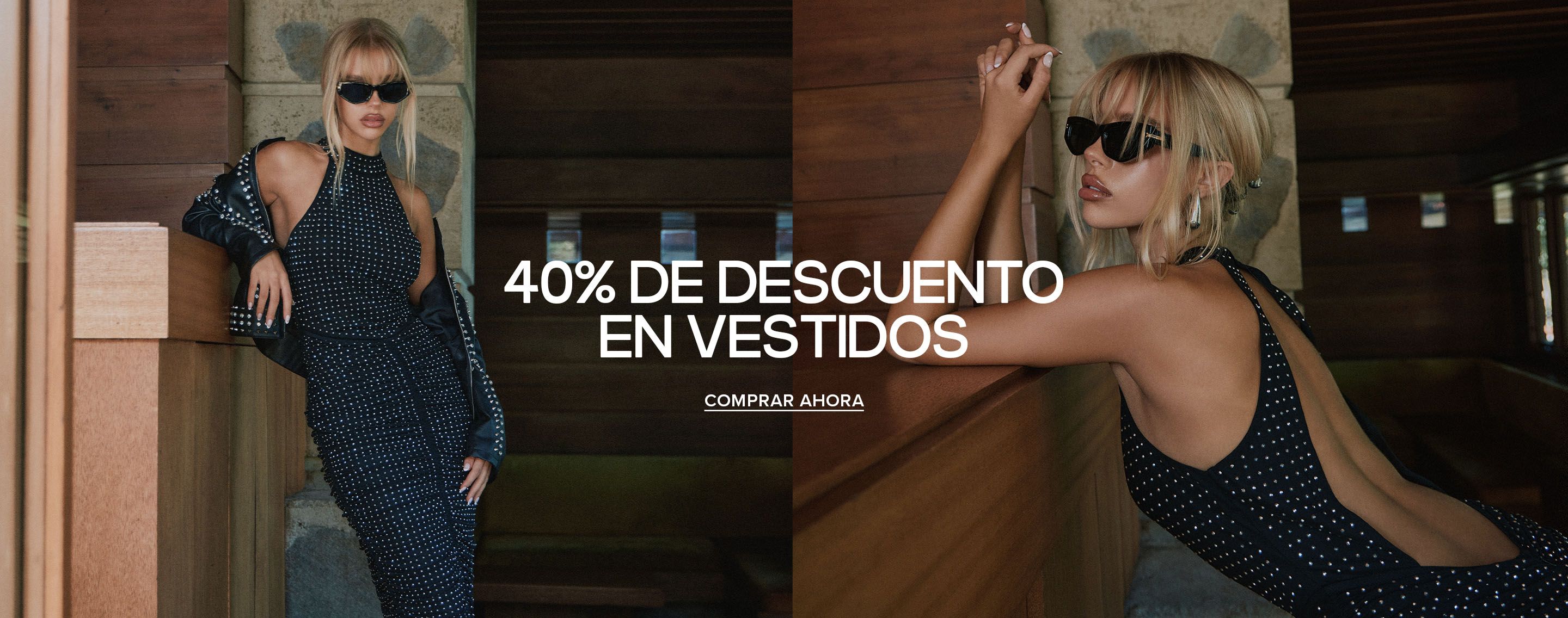 Mujer rubia con un vestido halter negro con tachuelas y chaqueta de cuero posa junto a paneles de madera por la oferta del 40% en vestidos.