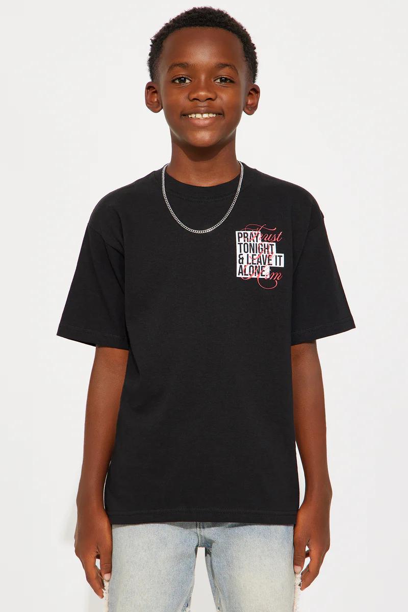 Young boy in black "Pray Tonight & Leave It Alone" graphic tee & silver chain. Youth fashion.