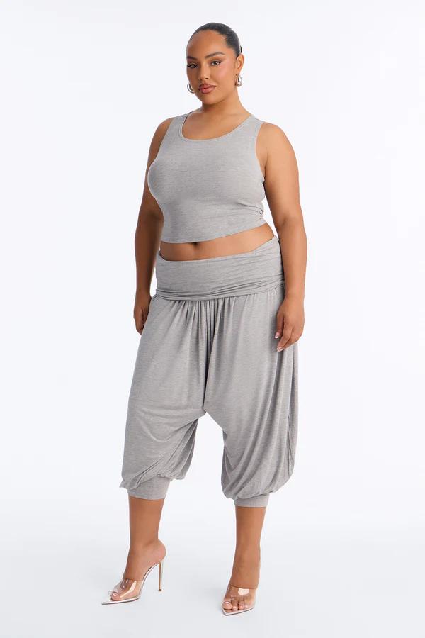 Confident model in a comfortable gray cropped tank top and matching harem pants, highlighting the versatile new loungewear collection.