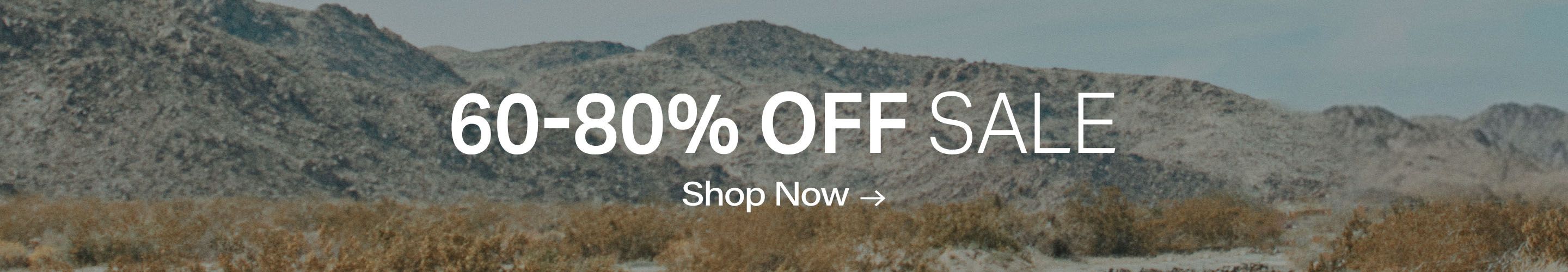 60-80% OFF SALE, Shop Now! Muted desert landscape background with gray mountains and dry brush for great discounts.