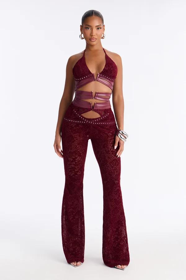 Model poses in a trendy maroon cutout halter top and matching textured flared pants, highlighting the brand’s new festival fashion collection.
