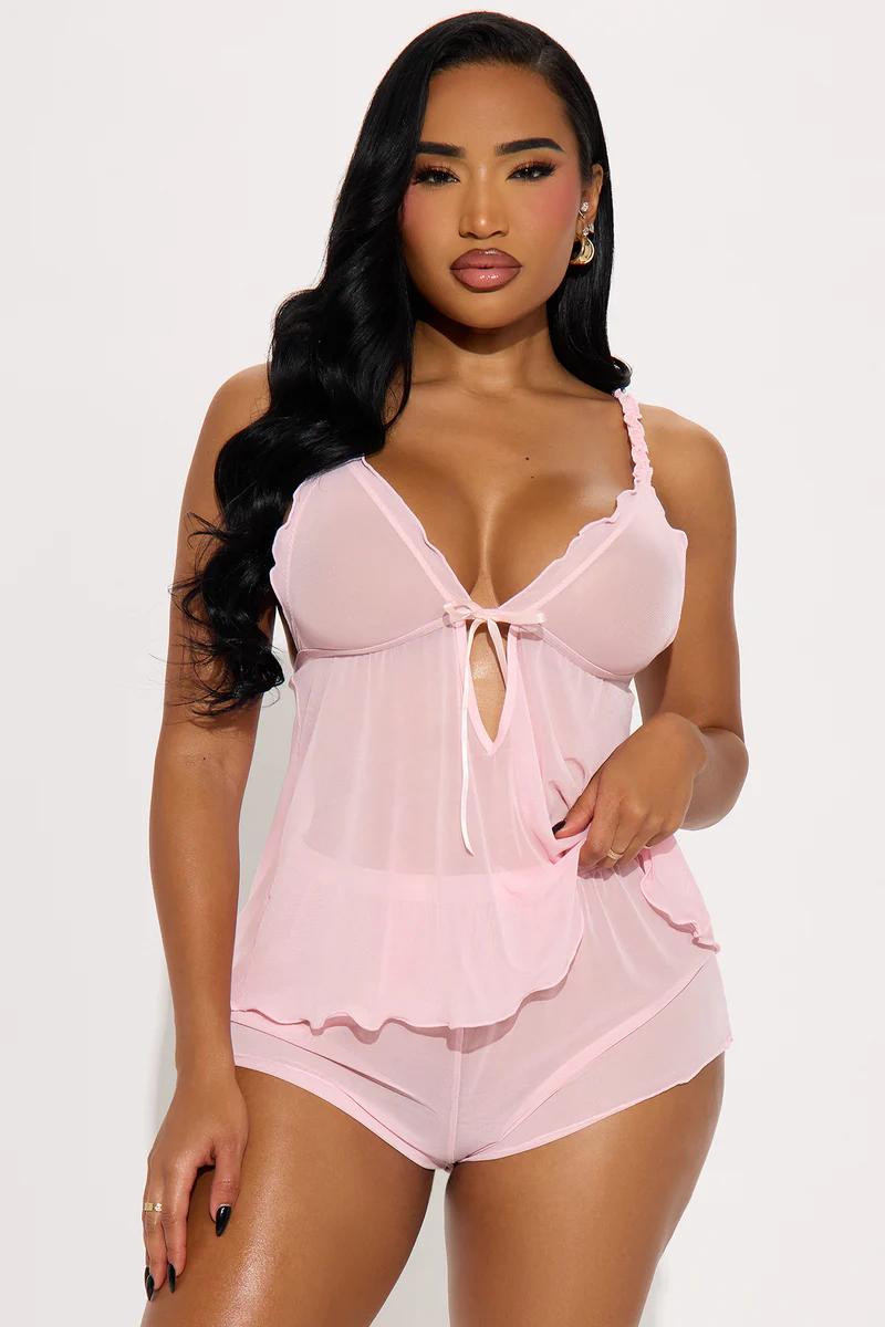 Woman modeling a light pink sheer babydoll top and matching shorts. Shop this beautiful new lingerie and sleepwear set.