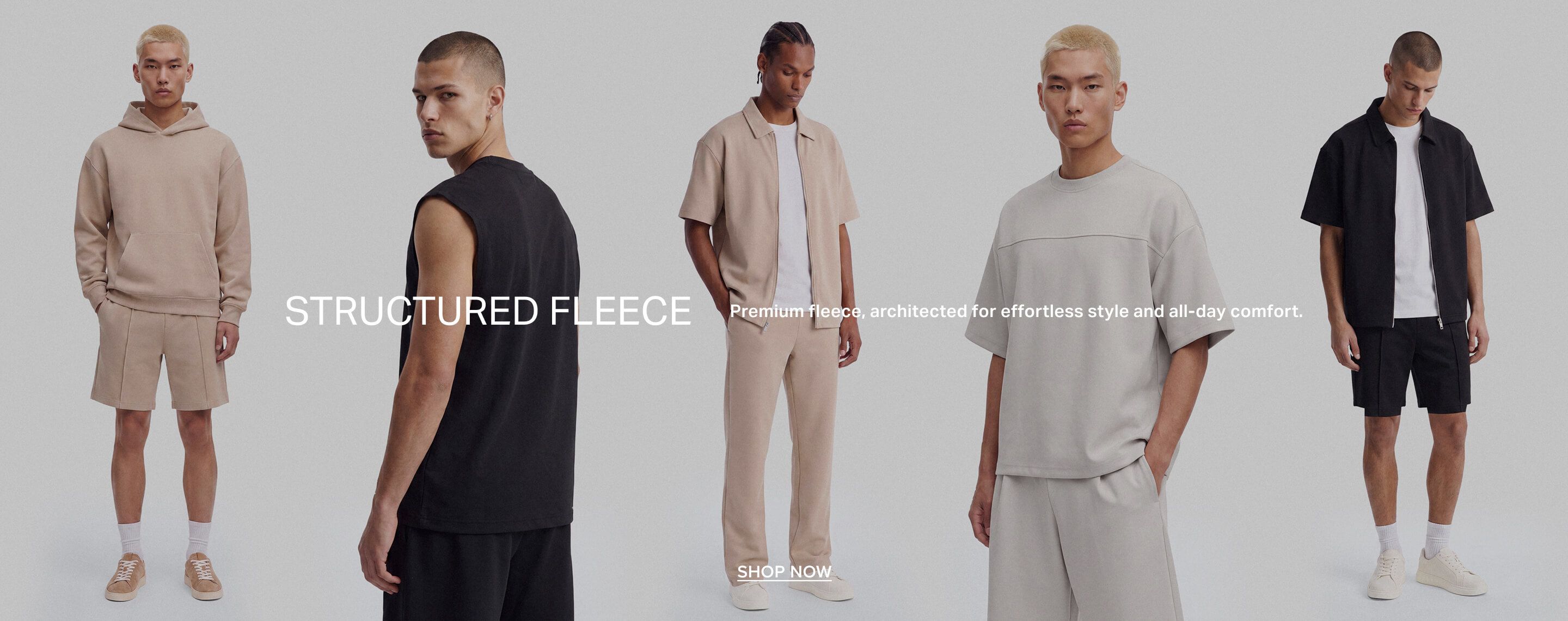 Two models in new structured fleece: black jacket/shorts, beige tee/shorts. Promotes premium, effortless style and all-day comfort.