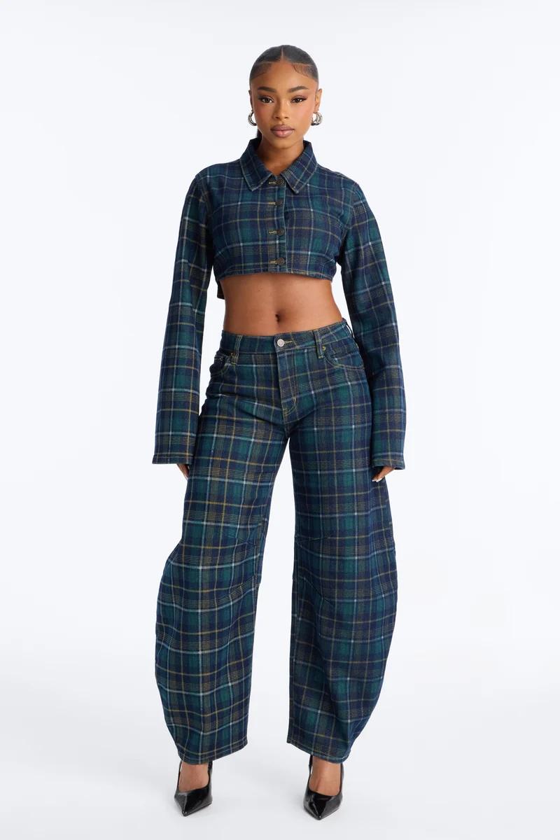 Model wearing a matching blue and green plaid crop top jacket and wide-leg trousers, showcasing a trendy new streetwear fashion collection.