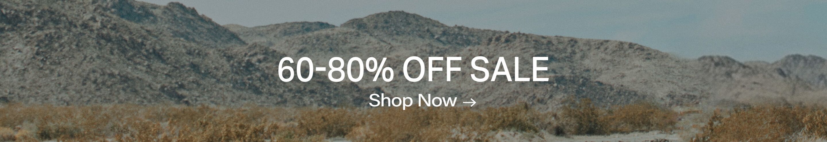 60-80% OFF SALE, Shop Now! Muted desert landscape background with gray mountains and dry brush for great discounts.