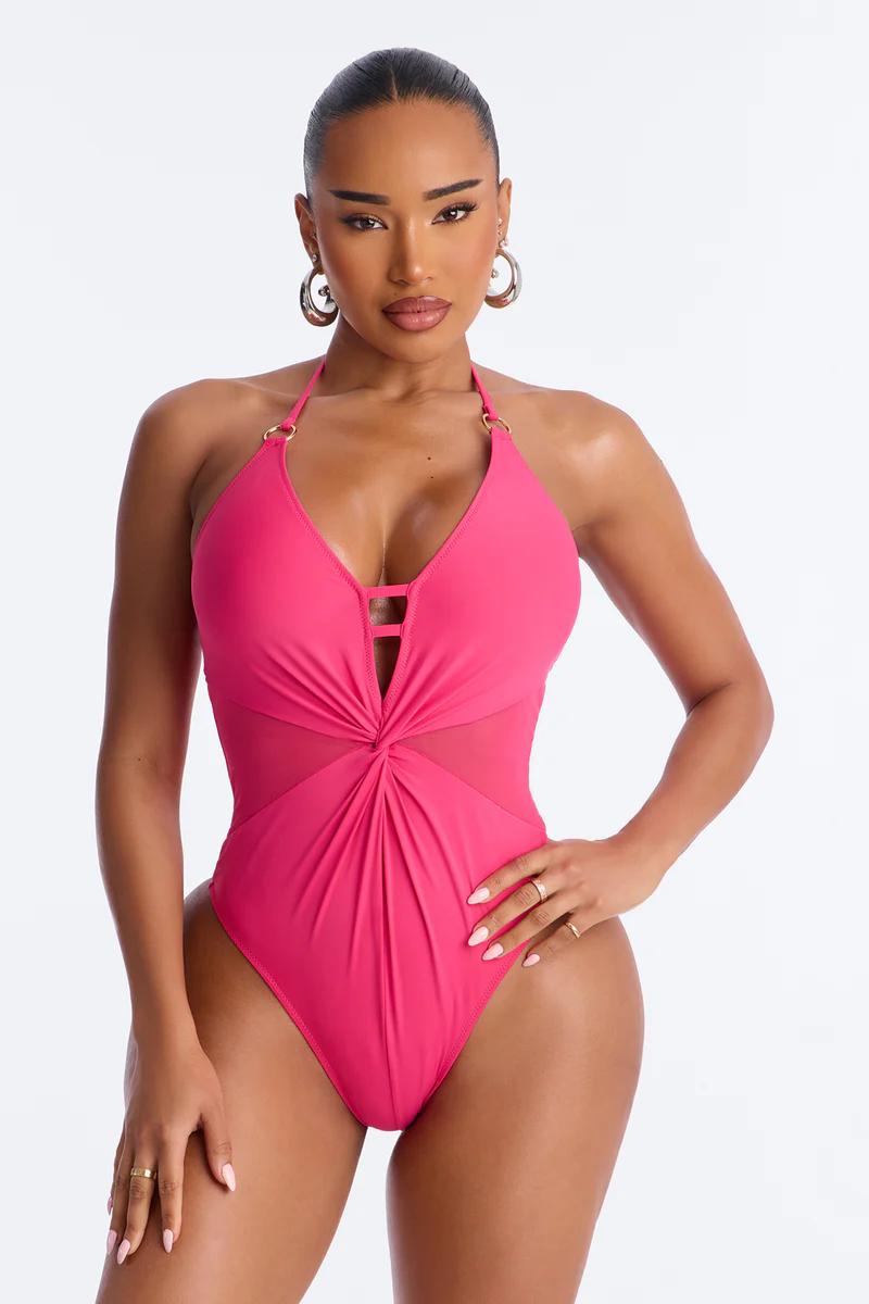 Hot pink halter one-piece swimsuit features a plunging neckline, mesh cutouts & ruched front. Stylish women's swimwear.