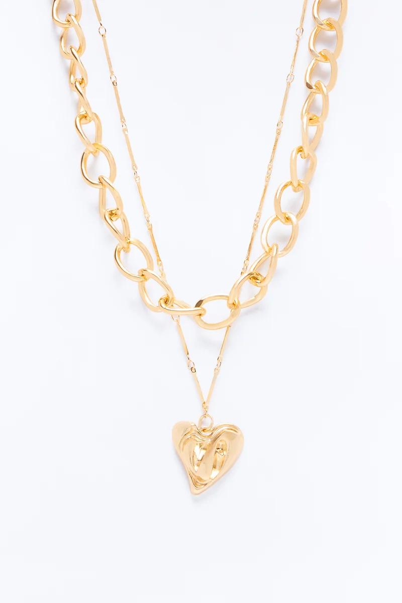 Layered gold chain necklace with a chunky link chain and delicate heart pendant.