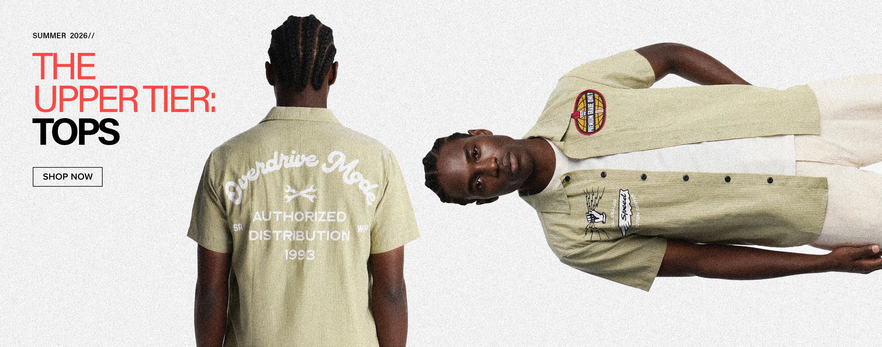 Man modeling a light green striped short-sleeve top and cream pants from the Summer 2026 "Upper Tier: Tops" collection. Shop now.