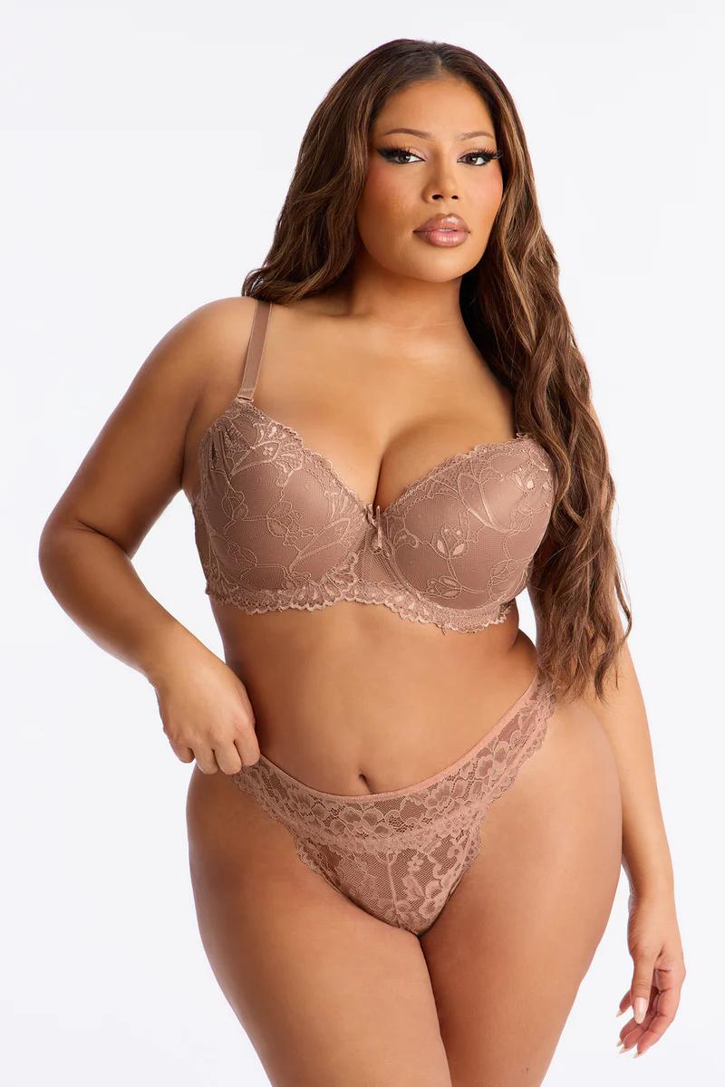 Plus size model in nude lace bra and thong. Supportive, elegant lingerie set for curvy women.