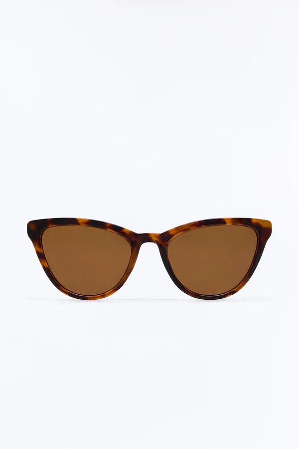 Stylish tortoiseshell cat-eye sunglasses featuring rich brown lenses, presented clearly and centered front-on against a bright, clean white background.