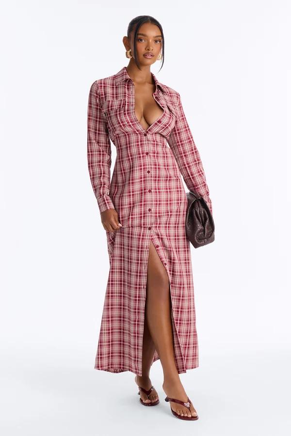 Woman wearing a red plaid maxi shirt dress with a high slit and brown clutch, showcasing a trendy women's fall fashion collection.