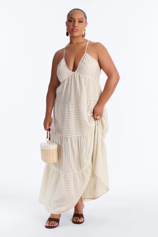 Woman modeling a plus size light blue floral print ruffled maxi dress with spaghetti straps and a high slit. Perfect summer fashion new arrival.
