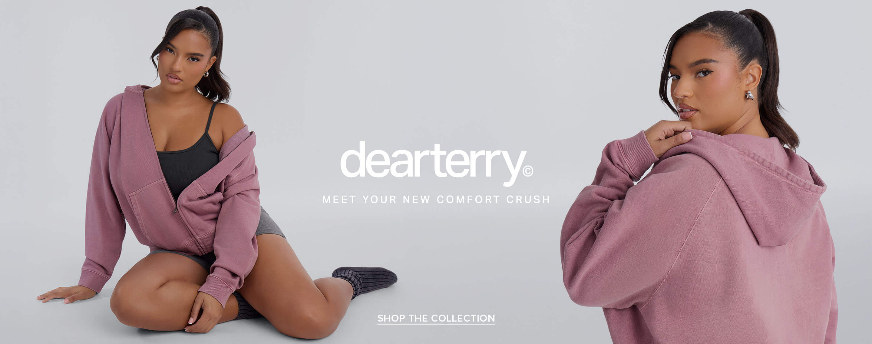 Woman sits in a dusty rose zip-up hoodie and grey activewear to promote the comfortable new Dear Terry loungewear collection.