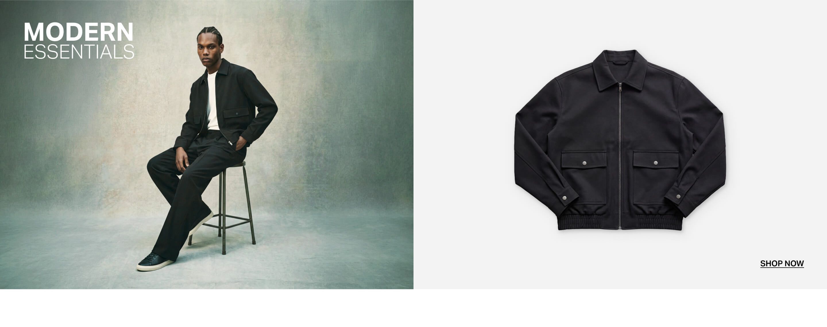 Man models modern essential black zip jacket, white tee, black pants, and sneakers, sitting on a stool. Shop sleek men's minimalist fashion.