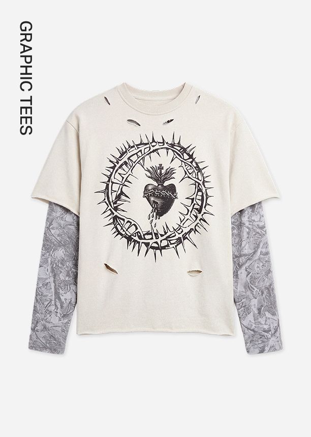 Cream distressed graphic tee with a black sacred heart and crown of thorns design, layered over grey patterned long sleeves for a grunge style.