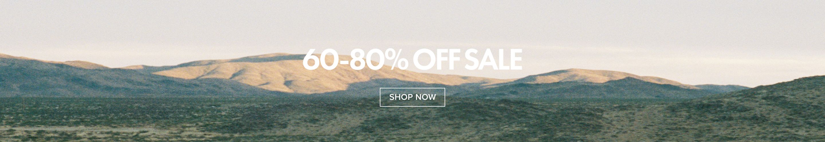 Desert mountain landscape promoting a 60-80% off sale, with a prominent "SHOP NOW" button for discount shopping.