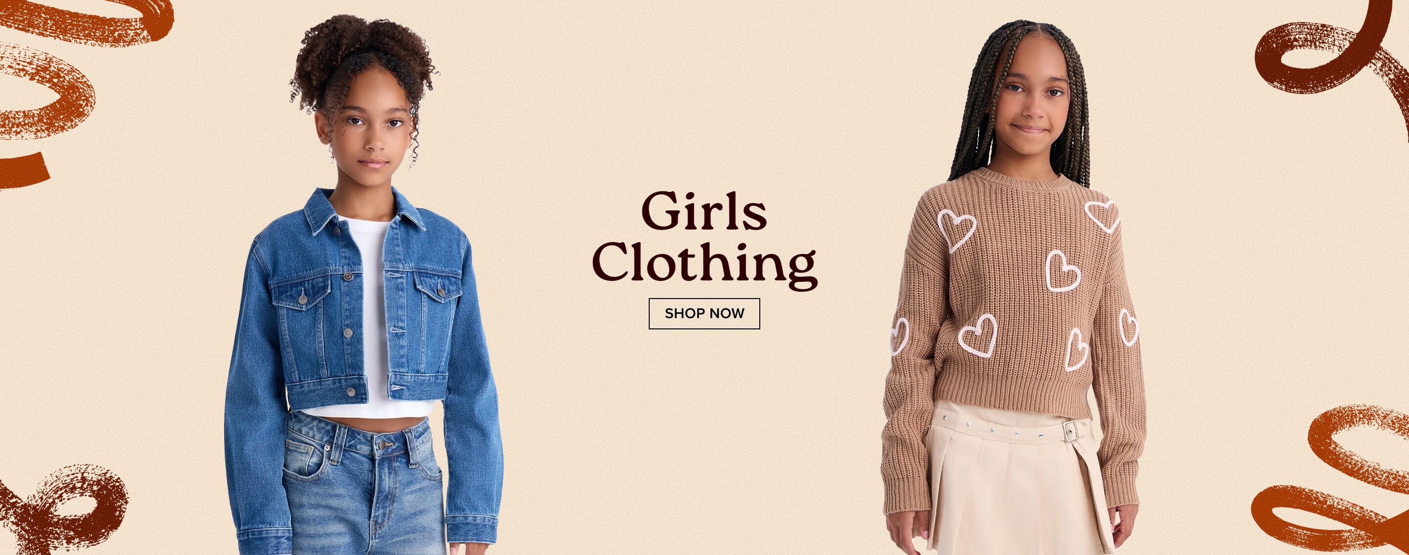 Two young girls model a denim jacket and a brown heart sweater for a Girls Clothing collection banner featuring a Shop Now button.