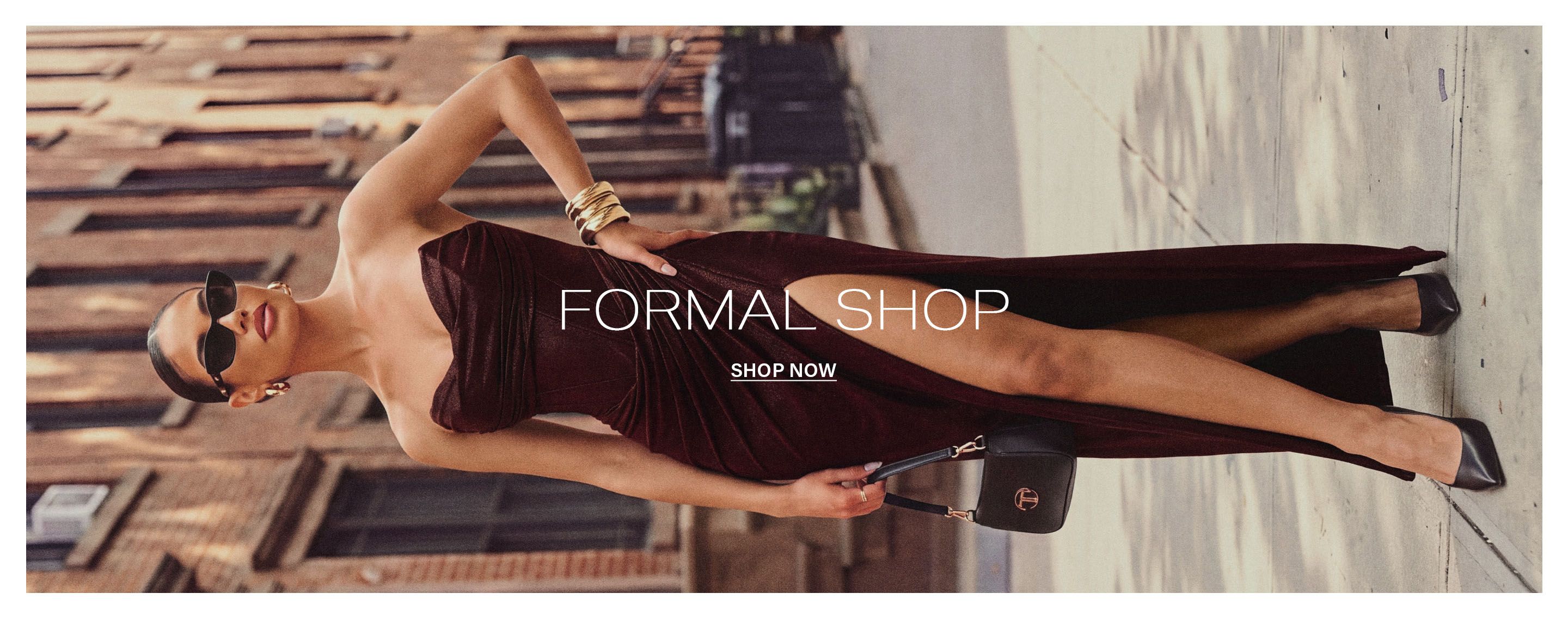 Chic woman in a strapless burgundy formal dress with a high slit poses on a city street. Overlay text reads: Formal Shop, Shop Now.
