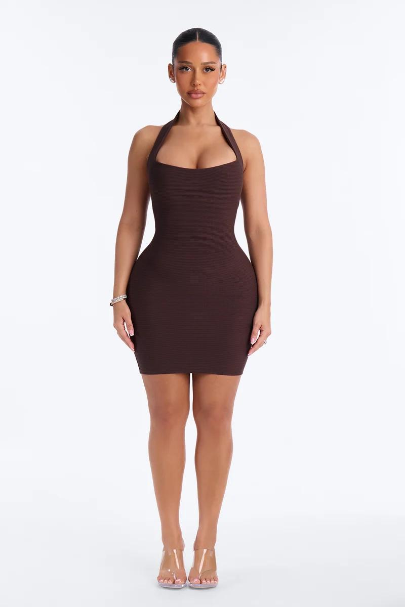Model showcasing a chic dark brown halter bodycon mini dress with ribbed knit texture for a sleek evening fashion shop collection look.
