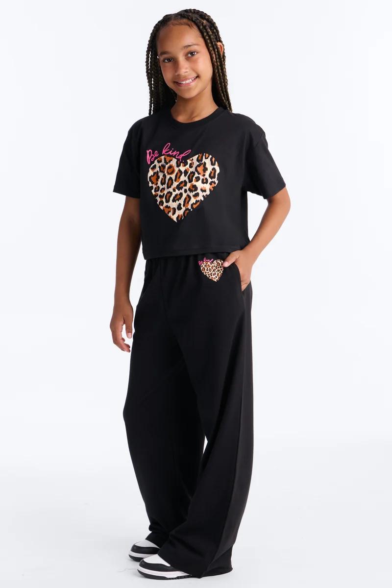 Girls black loungewear set featuring a 'Be Kind' leopard print heart t-shirt and matching wide-leg sweatpants.