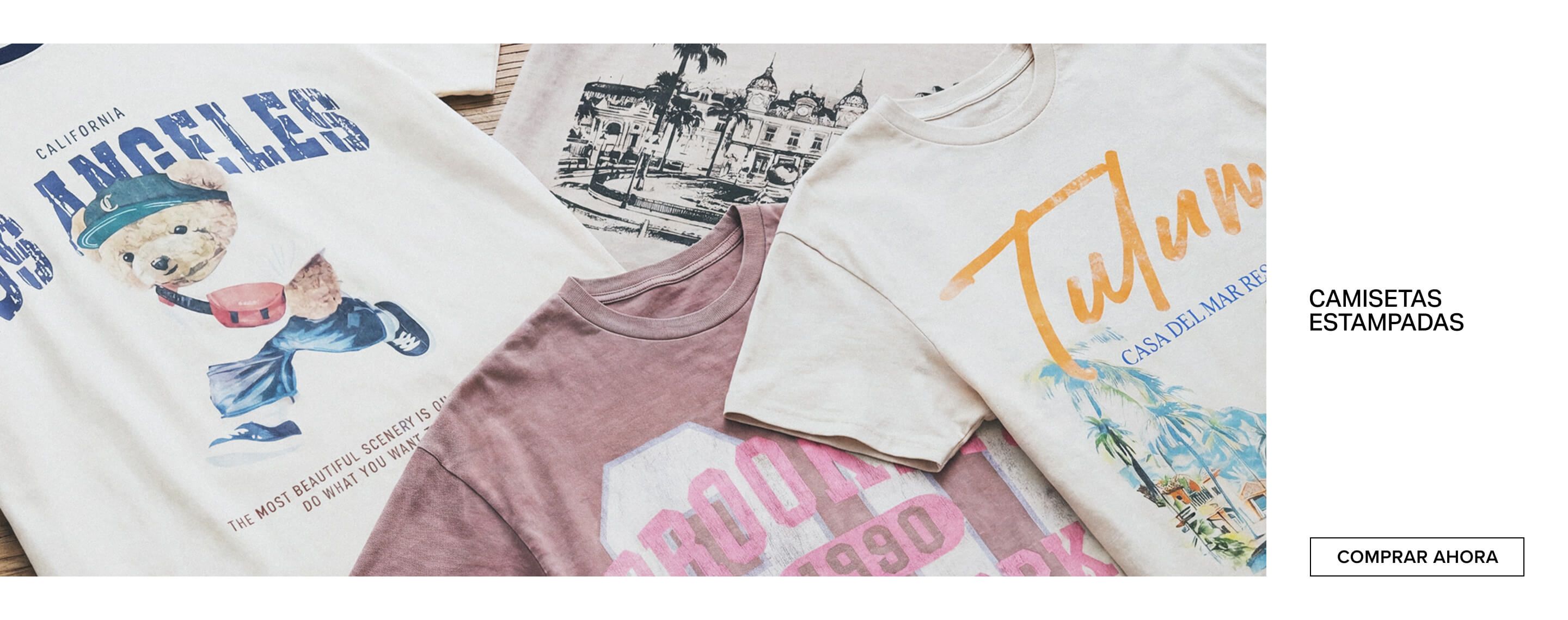 Tres camisetas gráficas dobladas: beige Mónaco, beige claro Tulum y malva Brooklyn. Promocionando moda casual de viaje con estilo.