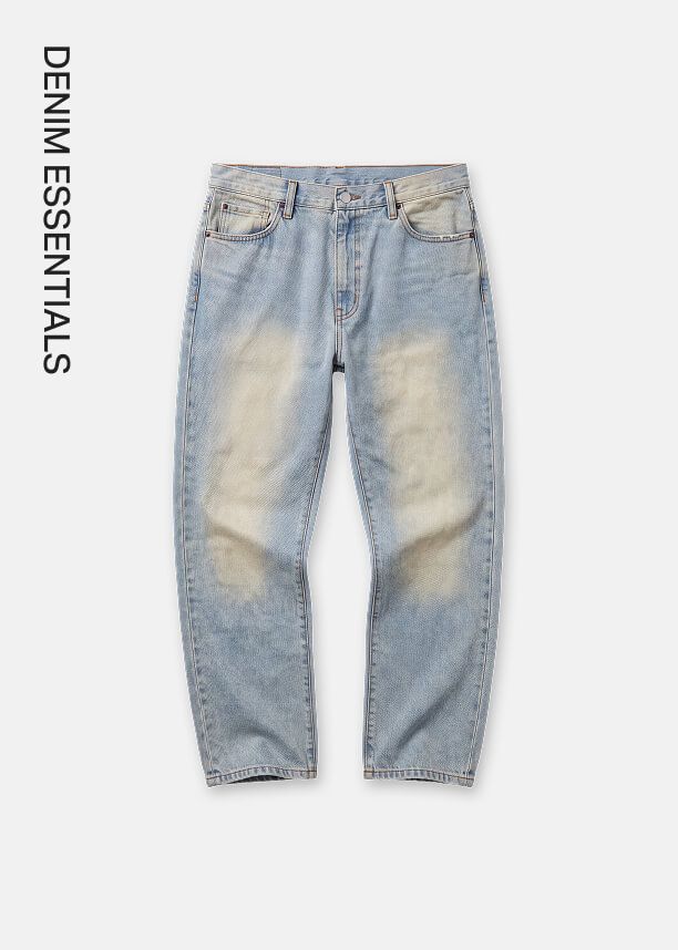 Light blue vintage washed denim jeans with faded thighs laid flat, showcasing the new Denim Essentials modern casual collection.
