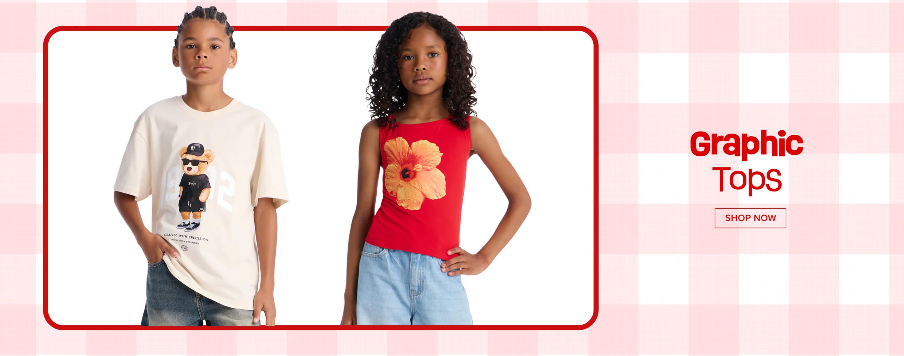 Two children modeling stylish graphic tops: boy in beige bear tee, girl in red hibiscus tank. Shop our new collection of trendy kids' fashion!