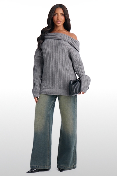 Cozy fall fashion featuring a grey ribbed off-the-shoulder knit sweater paired with faded wide-leg denim jeans and a black clutch.