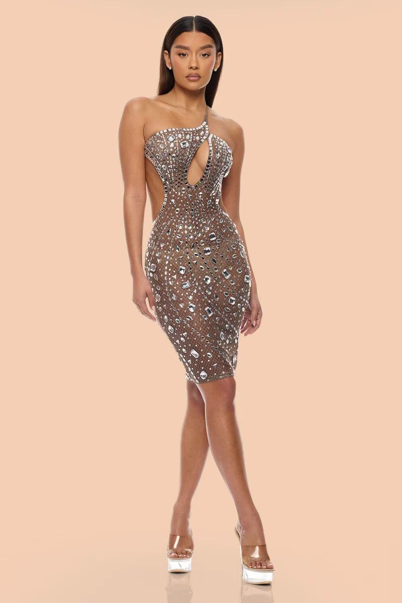 Woman in a dazzling one-shoulder rhinestone cocktail dress with a chest cut-out, showcasing elegant evening wear for a chic party look.