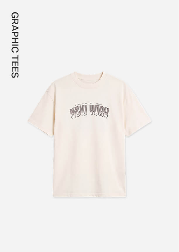 Light blue oversized graphic tee printed with 'ChaCream-colored printed t-shirt featuring a 'New York' graphic on the chest, showcasing a new casual streetwear apparel collection.se the Vision' white text, showcasing the brand's new casual graphic tees collection.