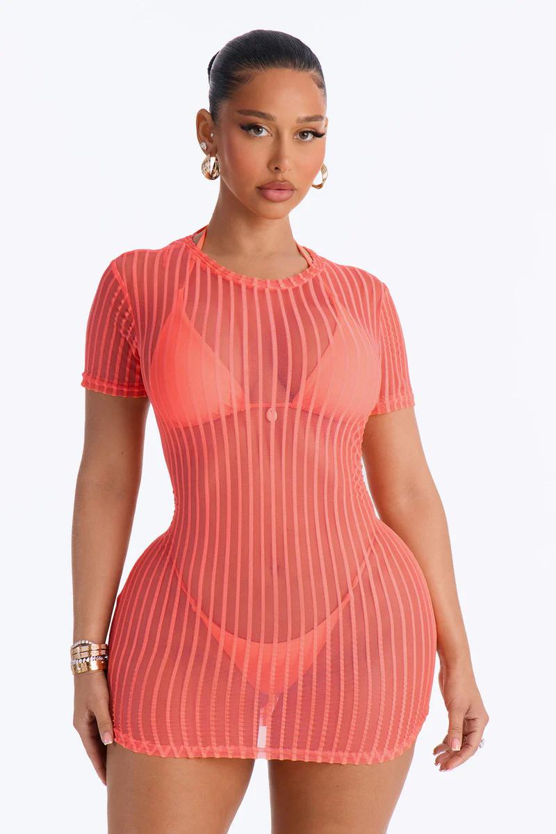 Coral striped mesh cover-up dress over matching bikini. Stylish women's beachwear.