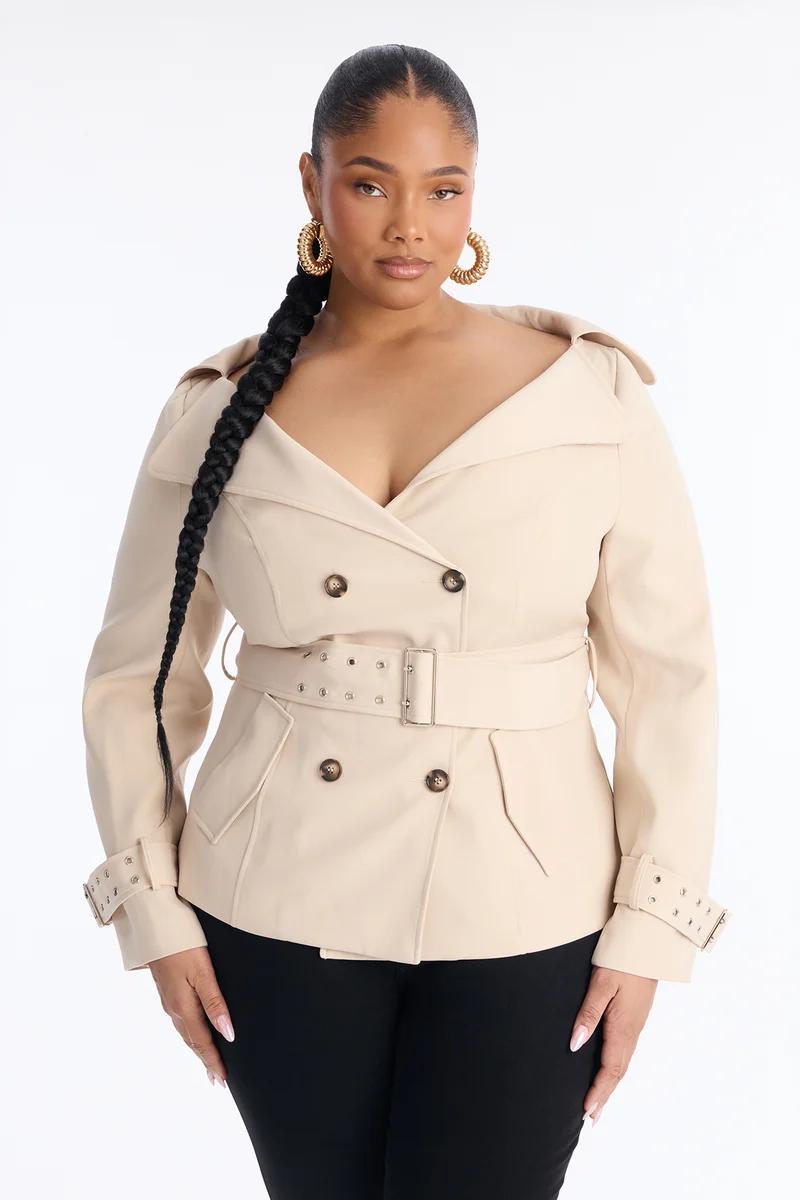 Curvy woman in a beige off-the-shoulder belted blazer jacket.